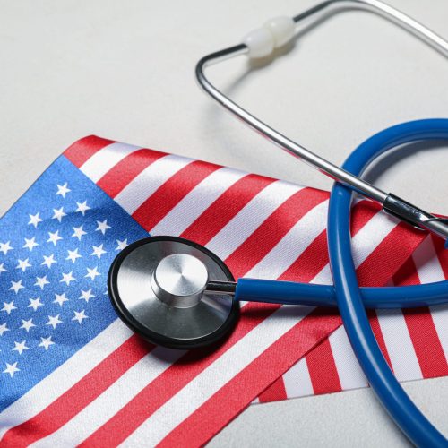 Stethoscope,With,Usa,Flag,On,Light,Background,,Closeup